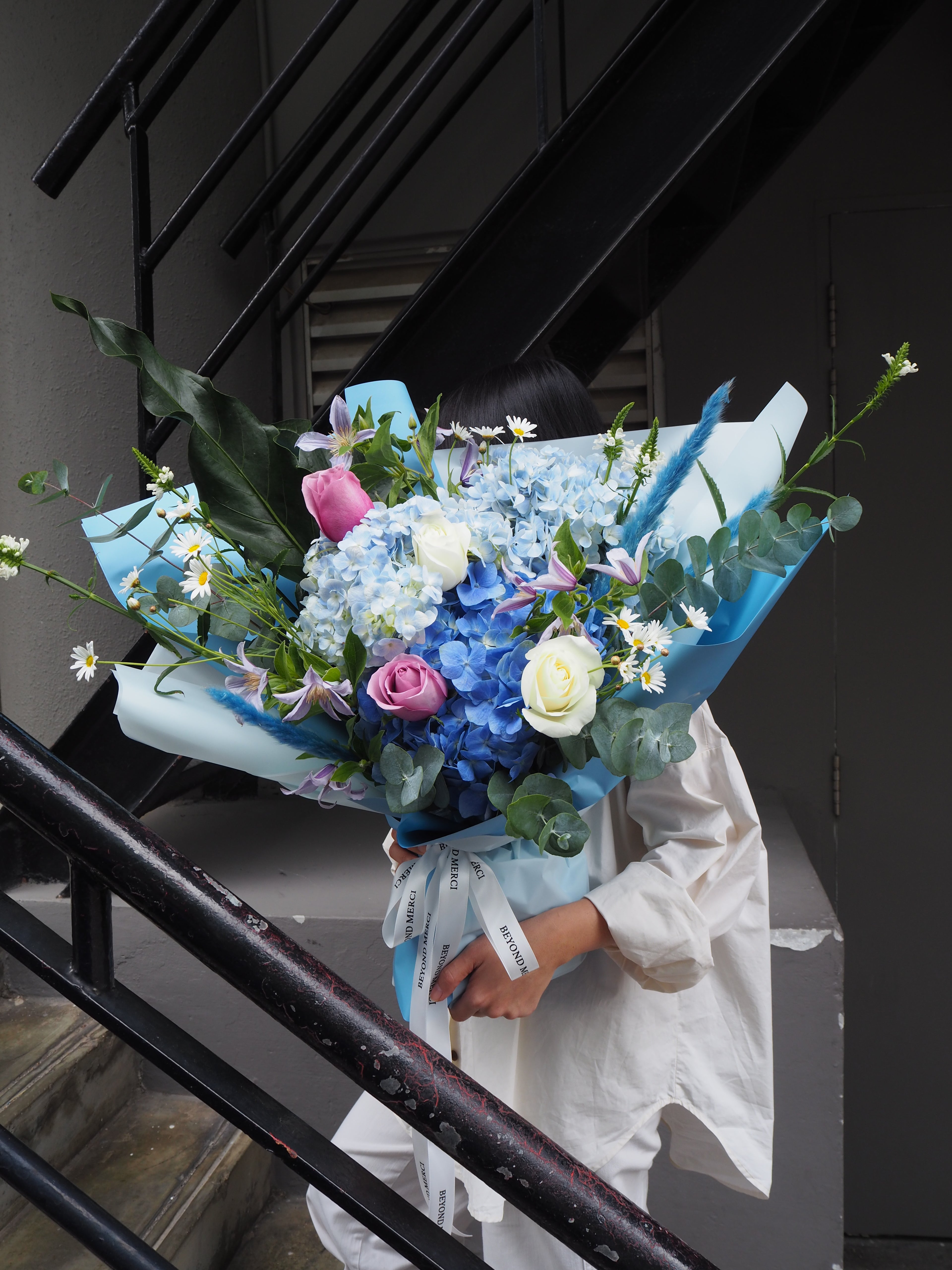 Unique luxury fresh flower bouquet with blue hydrangeas and purple roses