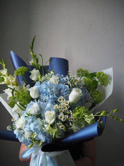 Bouquet of flowers with blue ribbons on a plain background