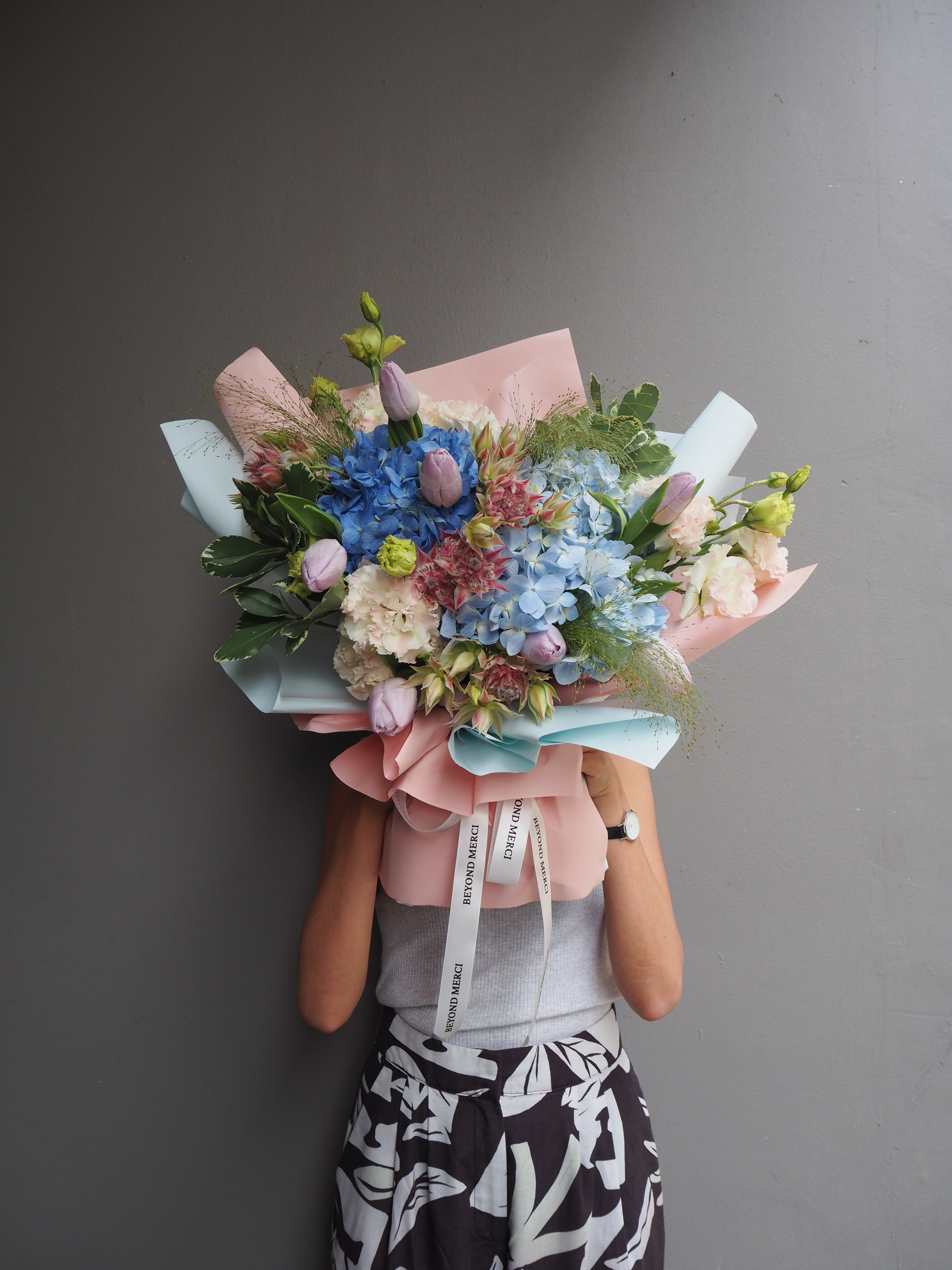 Brume luxury bouquet — two-tone blue hydrangea and pink tulip bouquet with dusty rose wrapping by Beyond Merci Singapore 
