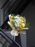 Grand fresh flower bouquet with a mix of pale blue hydrangea, yellow buttercup rose, pin cushion and green foliage.