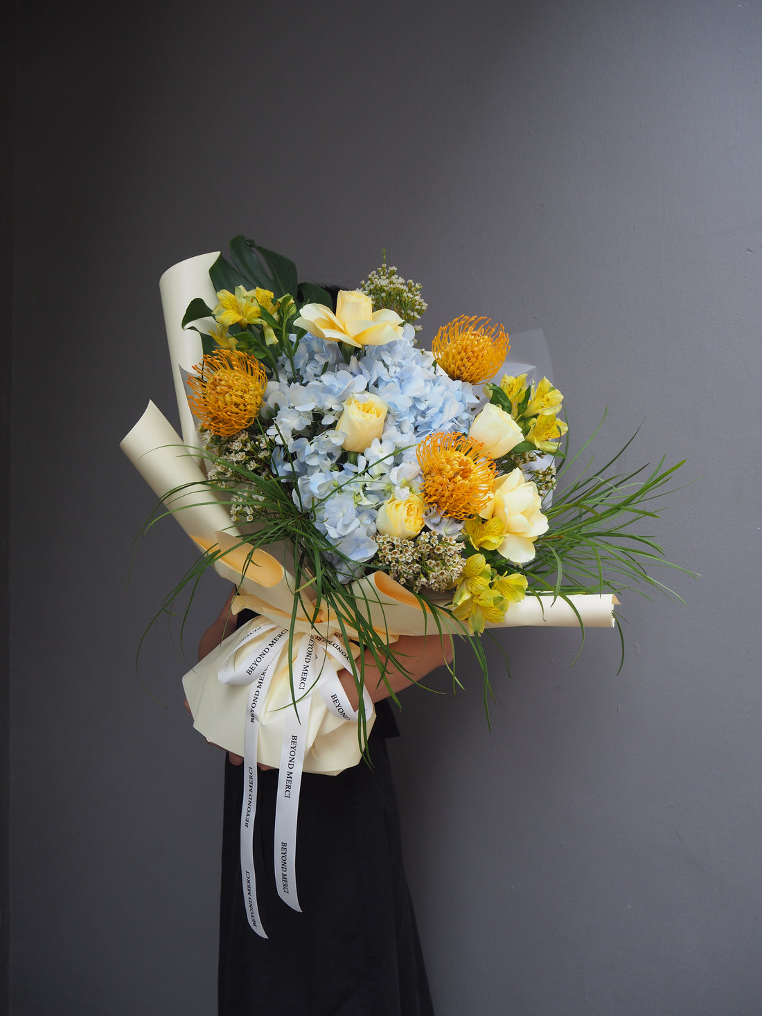 Garden inspirated fresh flower bouquet in unique blue and yellow tones.