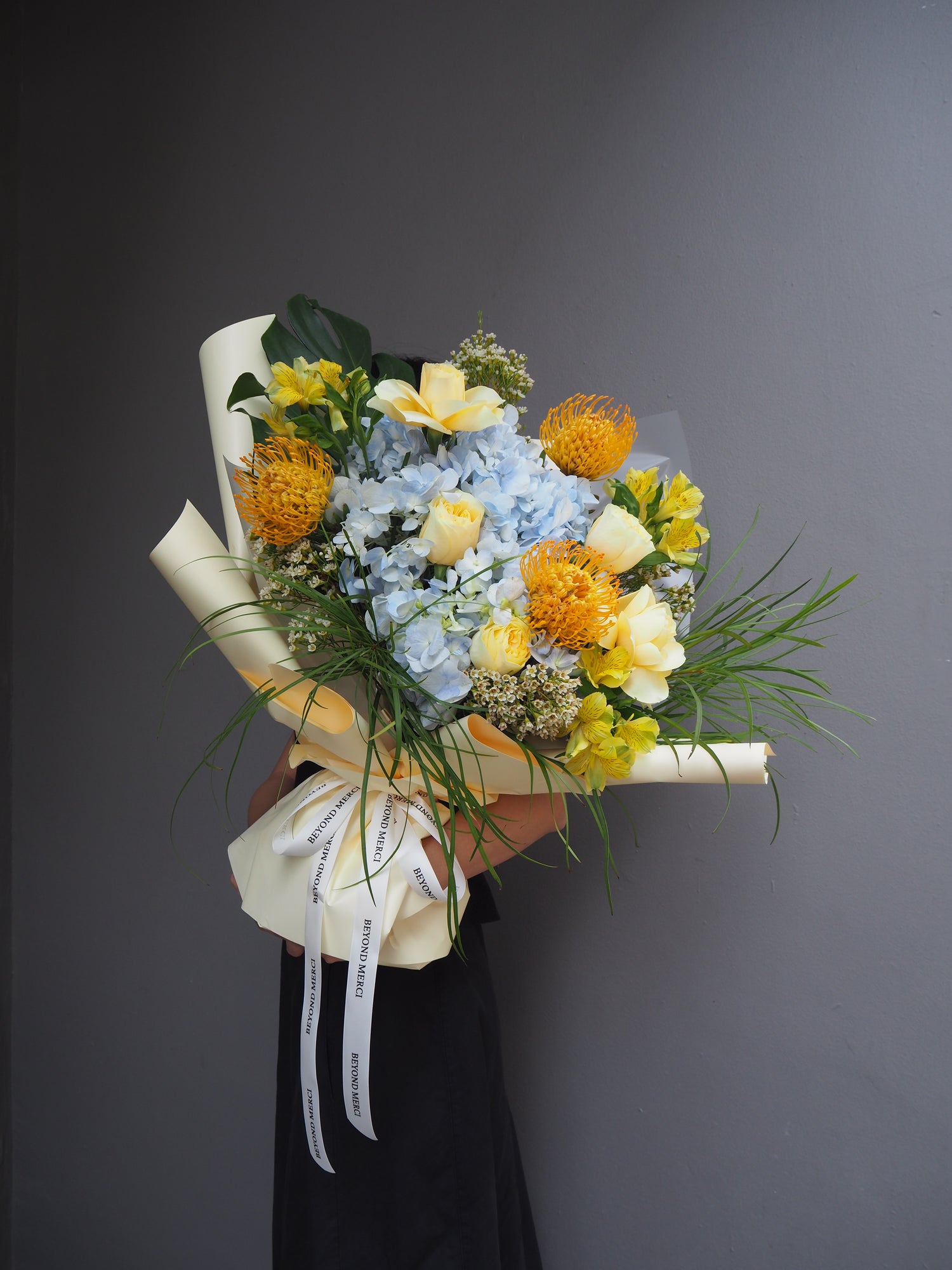 Garden inspirated fresh flower bouquet in unique blue and yellow tones.