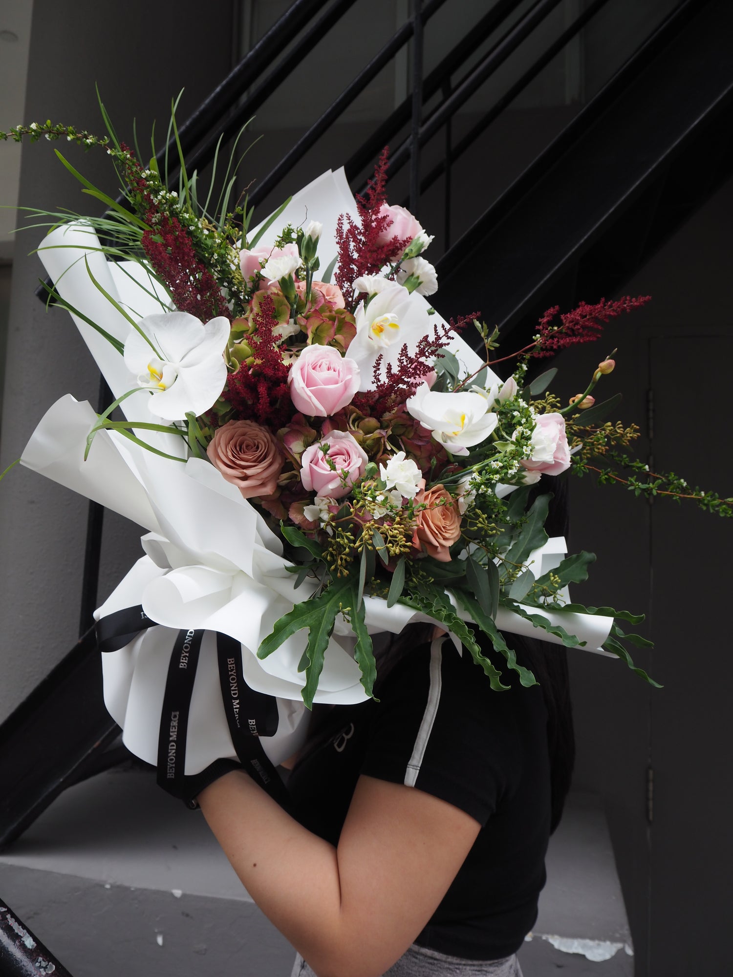 Bouquet of flowers held by a person in a car.
