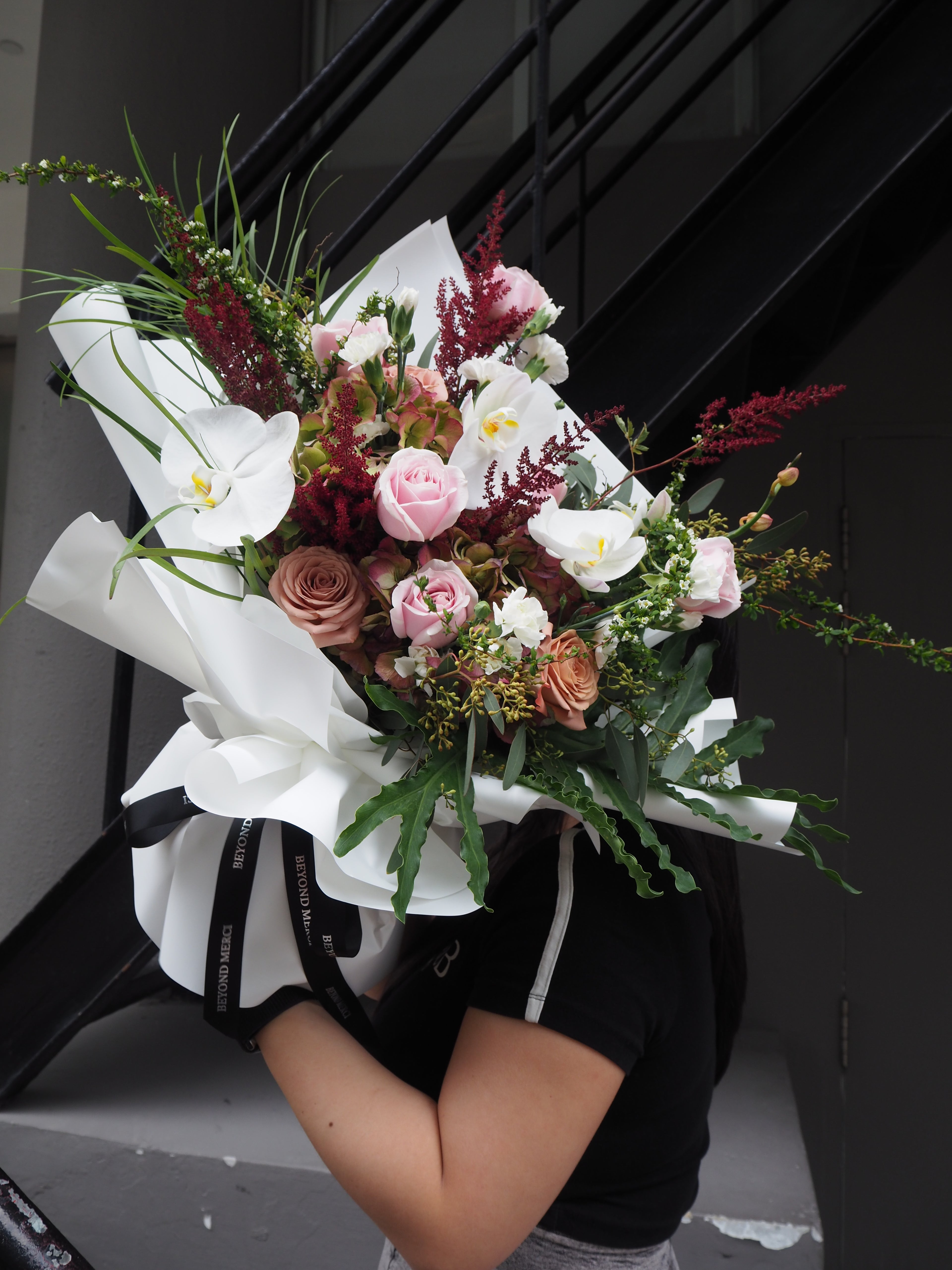 Bouquet of flowers held by a person in a car.