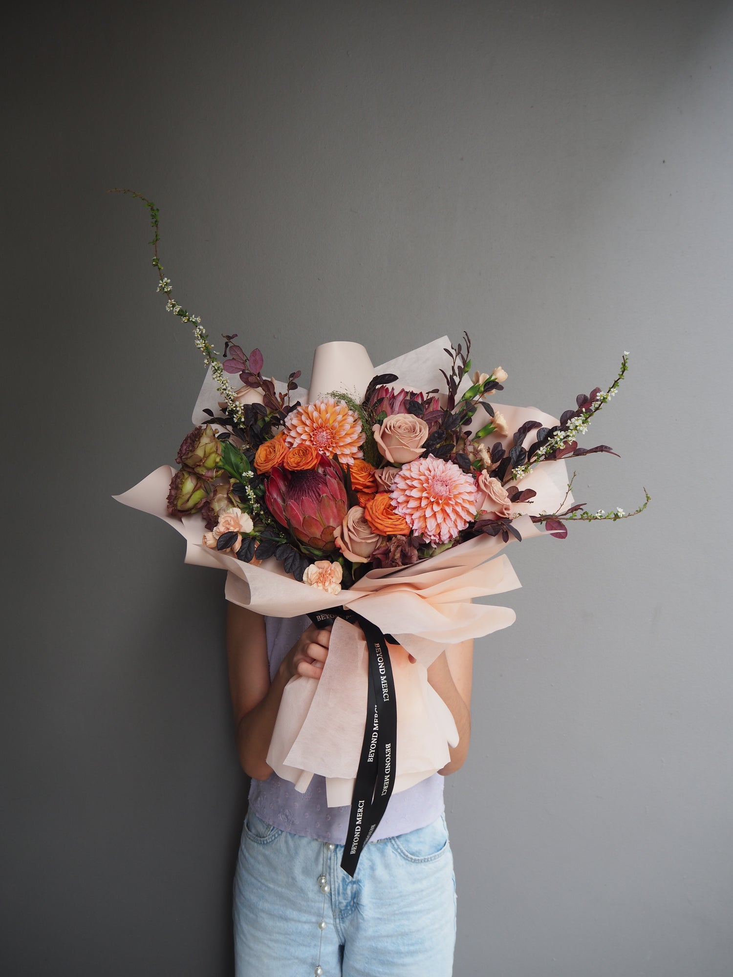 Premium bouquet of fresh flowers with cappucino rose, dahlia and protea for an autumn feel bouquet.